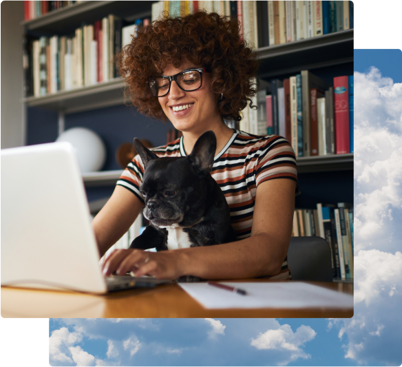 Person at laptop with a dog her lap typing